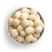 Natural macadamias in white bowl