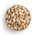 Roasted and salted pistachios in shell in white bowl freestanding